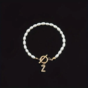 Elegant white pearl bracelet with gold OT clasp and sparkling rhinestone Z pendant