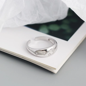 Macro shot of silver S925 star and moon open ring with sparkling diamond inlay