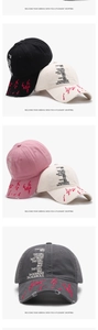 Detail of distressed baseball caps in multiple colors with embroidery and graffiti style