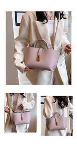 Detail of pink pebbled leather tote bag featuring a cylindrical gold hardware lock closure