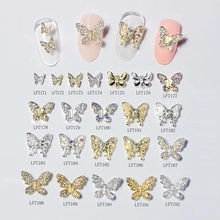 Macro display of assorted starfish and butterfly nail charms in metallic gold and silver finishes