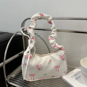 Floral canvas shoulder bag with pink roses, bow prints, and ruched handle strap detail