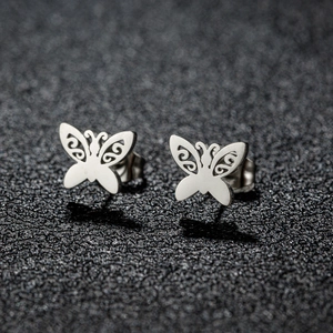 Detailed macro view of French vintage butterfly stud earrings in polished silver steel