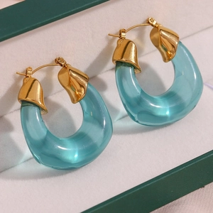 Modern gold-plated U-shaped earrings with translucent blue resin drops in a gift box