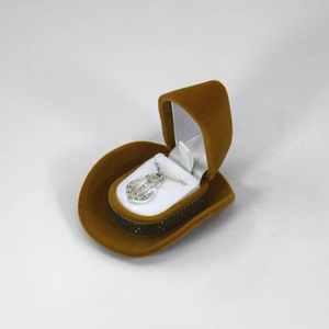 Detail view of brown cowboy hat jewelry box with silver anchor necklace inside