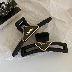Minimalist black acrylic shark hair claw clips with golden POWER triangle metal plate
