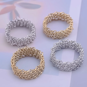 Modern grid mesh rings in 18K gold and silver finishes on minimalist background