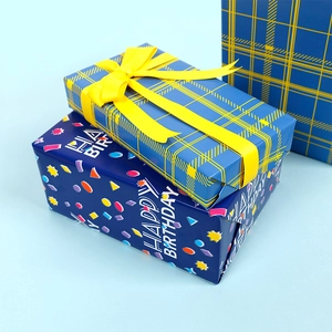 Macro shot of blue and yellow gift wrapping paper with dots and ribbons for birthday gifts