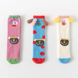 Detailed view of three colorful cartoon coral fleece socks with cute 3D animal patterns