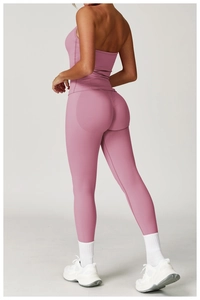 Side view of dusky pink high-waisted seamless yoga leggings and halter neck sports bra set