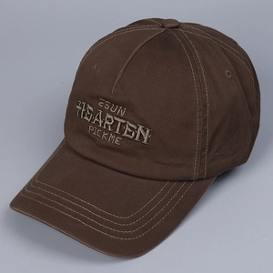 Detail of dark brown baseball cap with 3D letter embroidery and reinforced brim stitching