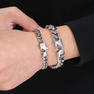 Silver Cuban chain bracelets in two thicknesses shown on wrist with metal luster