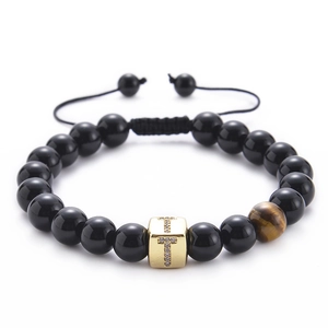 Detail of tiger eye stone and crystal zircon letter T charm on black beaded bracelet