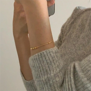 Minimalist 925 sterling silver snake chain bracelet with gold beads shown on wrist