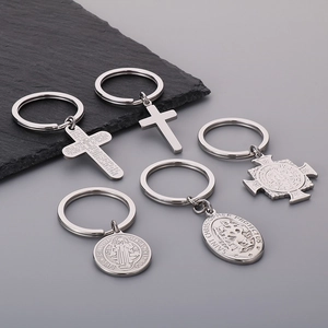 Detailed view of silver religious keychains with Saint Christopher and Cross charms