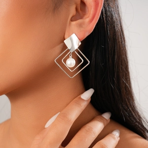 Minimalist silver geometric hollow diamond earrings with pearl drop on model closeup