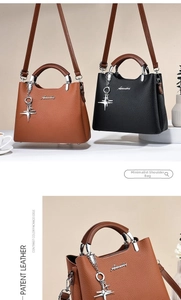 Detail view of brown and black structured handbags featuring contrast handles and metal charms