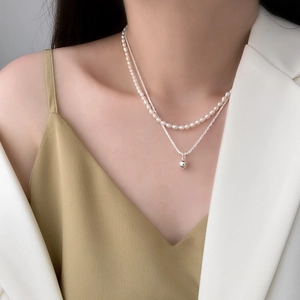 Double-layer necklace with white freshwater pearls and silver galaxy ball pendants