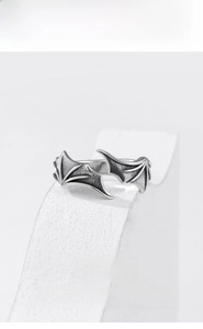 Detailed view of vintage silver demon wing ring with realistic bone textures