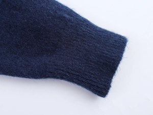 Detail of navy blue mohair knit cardigan featuring ribbed cuffs and soft texture