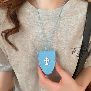 Detail of light blue leather glasses holder necklace with white cross and lanyard