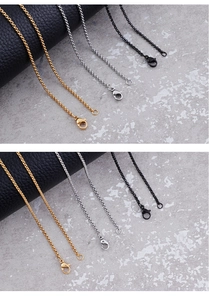 Detail of O-shaped rolo chains in gold, silver, and black with secure lobster clasps