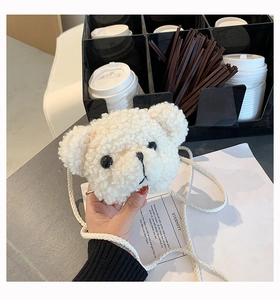 Close-up of fluffy white bear plush bag showing soft lamb wool texture and cute embroidery