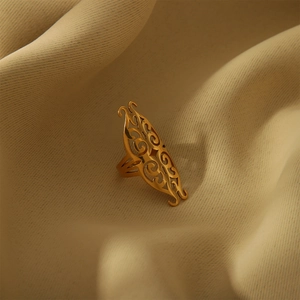 Vintage hollowed-out 18K gold-plated stainless steel open ring on soft beige fabric