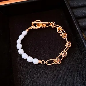 Elegant 18k gold plated pearl chain bracelet with OT toggle clasp on a black box