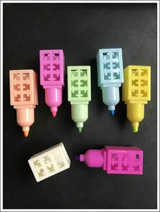 Close-up of seven colorful highlighters with unique grid caps on a black leather background