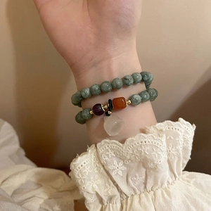 Double-layered beaded bracelet with green chalcedony and vintage bell charm pendant