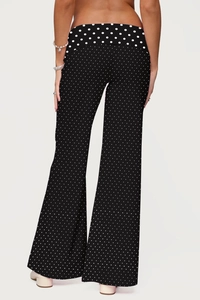 Back view of black and white polka dot wide leg trousers with a flowing high-waist fit