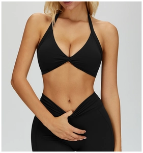 Close-up of black halter neck sports bra featuring a stylish front twist knot design
