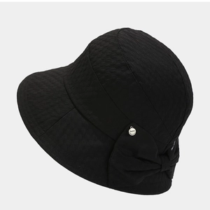 Textured black bucket hat for women with bow and silver charm detail on grey background