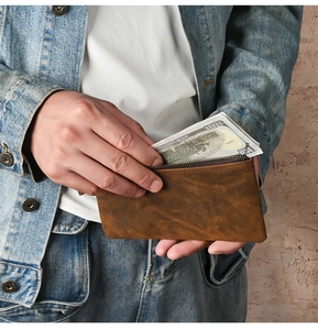 Close-up of a vintage brown crazy horse leather wallet filled with cash for capacity display