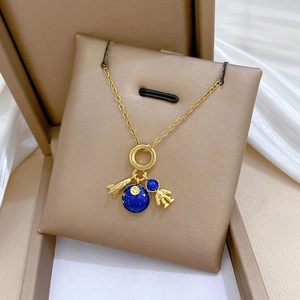 Space themed titanium steel necklace featuring gold astronaut, rocket and blue enamel planet