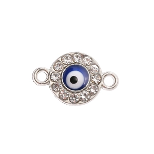 Micro shot of a silver evil eye charm with blue enamel and sparkling zircon accents