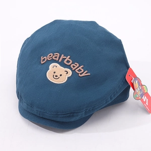 Close-up of dark blue cotton baby beret featuring bear embroidery and bearbaby lettering