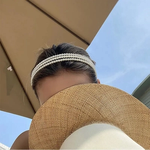 Three-layer pearl headband for women featuring a vintage French style against a blue sky