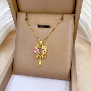 Detail of heart pendant with pink waterdrop gem and diamonds on fine gold chain