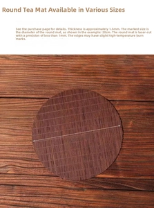 Detail of 1.5mm thick round bamboo tea mat with laser-cut edges on dark wood surface