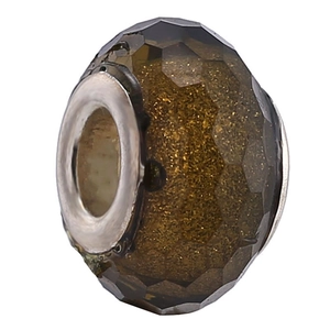 Macro shot of amber faceted resin bead with gold glitter and silver metal core