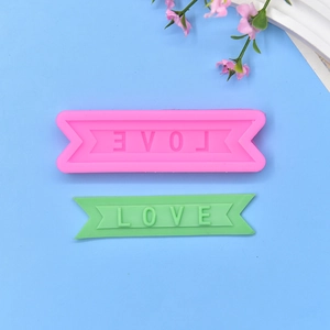 Pink silicone mold and green LOVE letter soap banner with dovetail design
