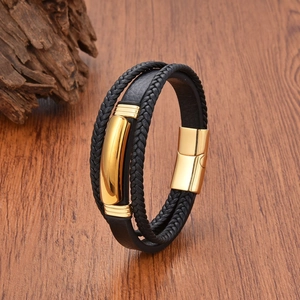 Men's multilayer black braided leather bracelet with golden magnetic buckle on wood