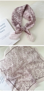 Detail view of purple floral cotton linen scarf showing texture and elegant knotting style