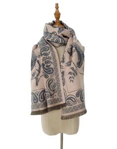 Detail of soft jacquard paisley scarf in cream and navy blue with elegant fringe trim