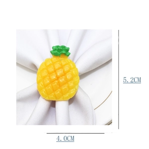Detail showing a 5.2cm pineapple napkin ring with green crown on white cloth