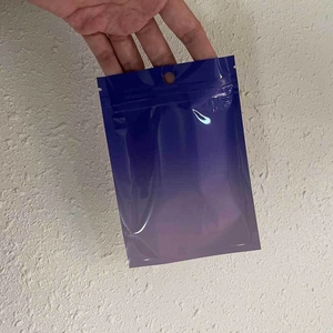 Detail of gradient blue to purple laser resealable packaging bag with zip lock and hang hole