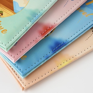 Close-up of PU leather passport covers featuring UV printing and fine stitching details
