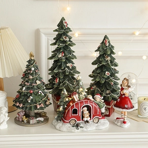 Resin Christmas tree and festive Santa figurines with warm holiday lighting display